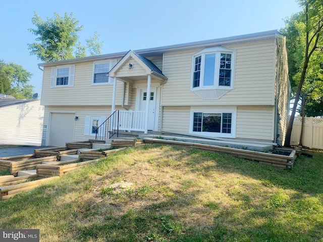 bi-level home featuring a garage and a front yard