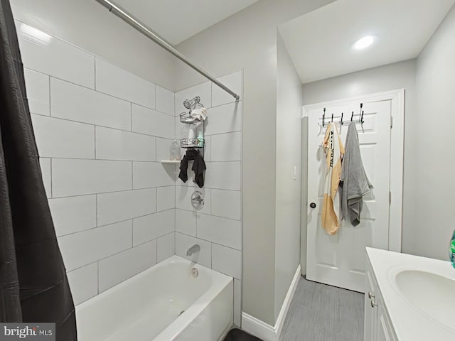 bathroom featuring shower / bathtub combination with curtain and vanity