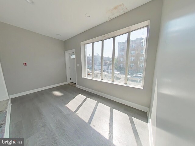 unfurnished room featuring hardwood / wood-style flooring