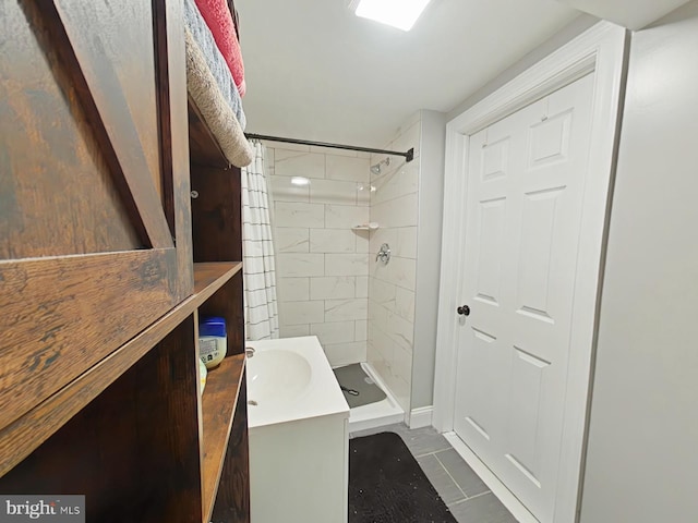 bathroom with tile patterned flooring and tiled shower