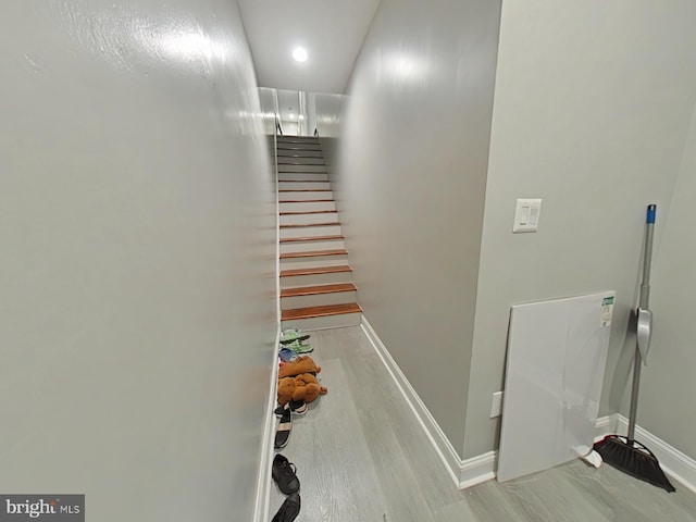 staircase with hardwood / wood-style floors