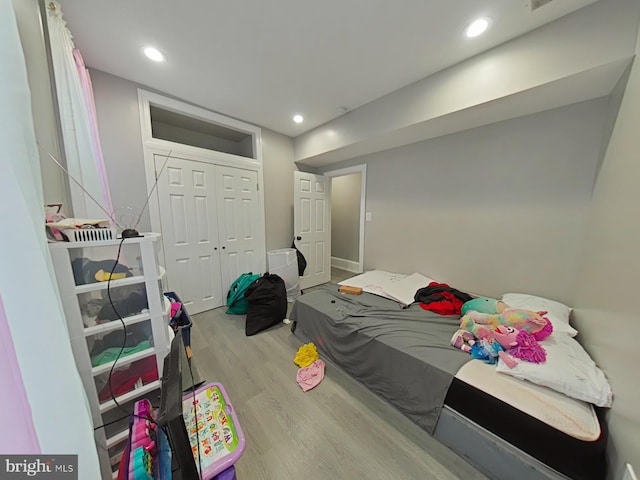 bedroom featuring light wood-type flooring and a closet