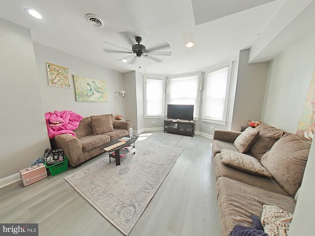 living room with ceiling fan and light hardwood / wood-style floors