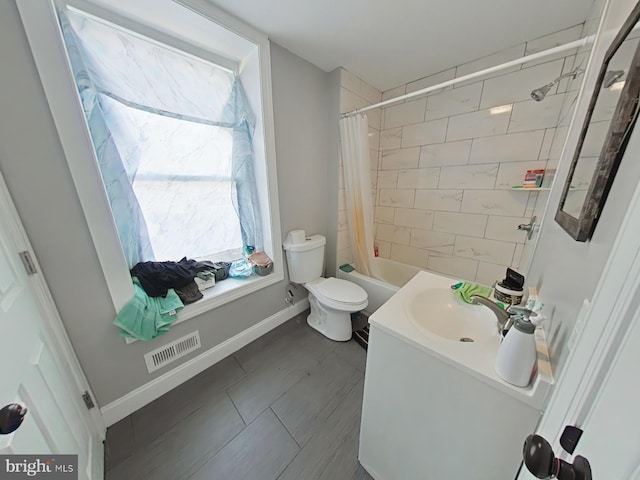 full bathroom featuring shower / bathtub combination with curtain, vanity, and toilet