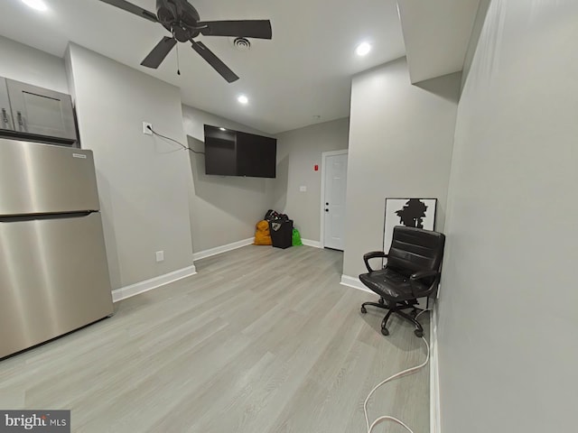 sitting room with light wood-type flooring and ceiling fan