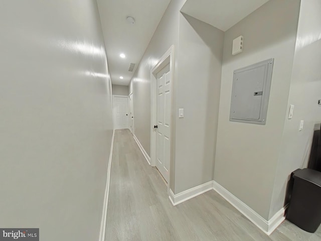 hallway featuring light hardwood / wood-style floors and electric panel