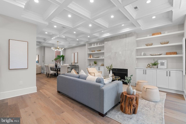 living room with built in shelves, coffered ceiling, light hardwood / wood-style flooring, and beamed ceiling