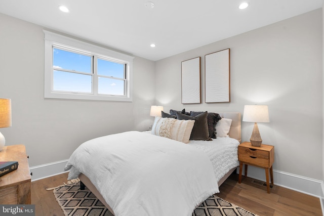 bedroom with hardwood / wood-style flooring