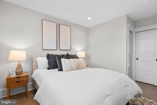 bedroom featuring hardwood / wood-style floors and a closet