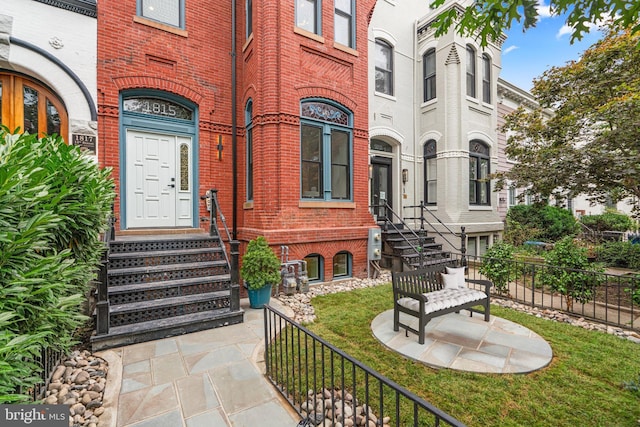 doorway to property featuring a lawn