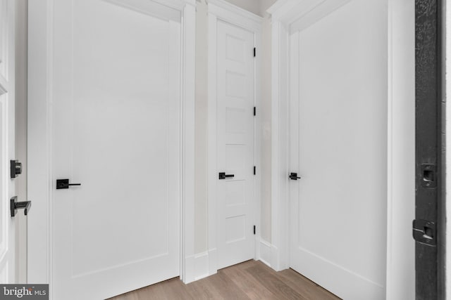 hallway with light hardwood / wood-style flooring