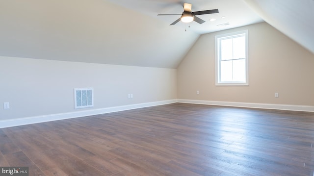 bonus room featuring vaulted ceiling, dark wood finished floors, visible vents, and baseboards