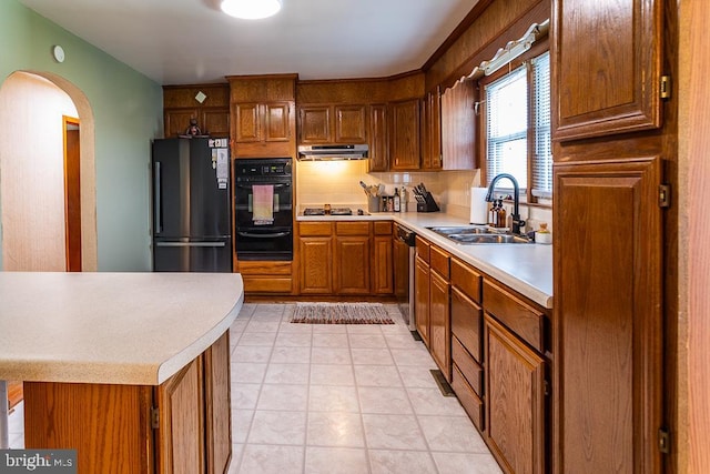 kitchen with sink, black appliances, and light tile patterned floors