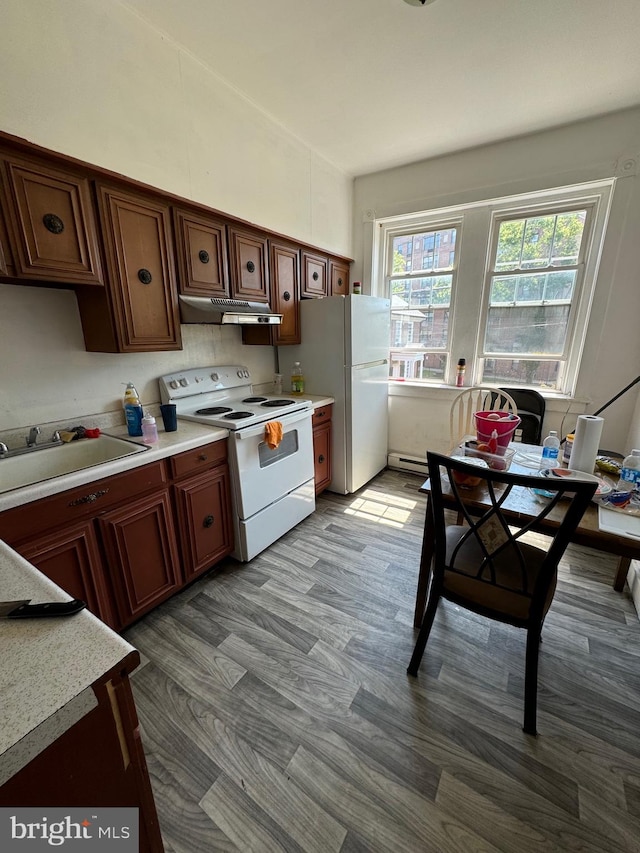 kitchen featuring a baseboard radiator, sink, light hardwood / wood-style flooring, and white appliances