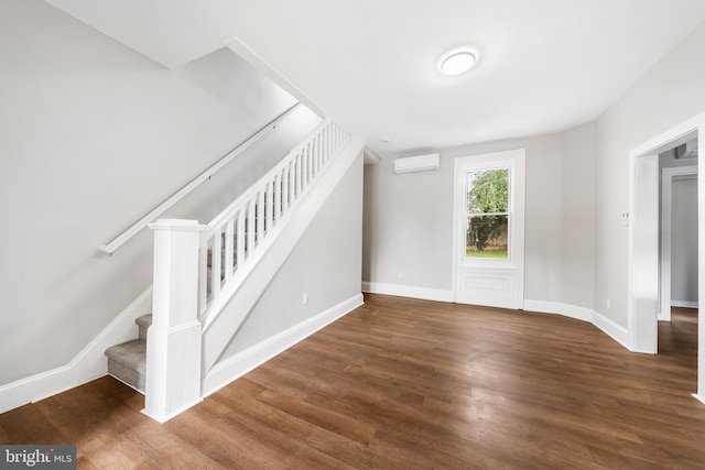 stairs with hardwood / wood-style flooring and a wall mounted AC