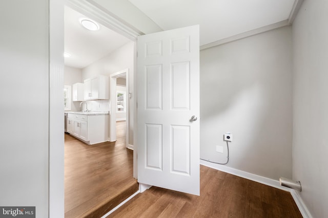 interior space with dark hardwood / wood-style floors, sink, and electric dryer hookup