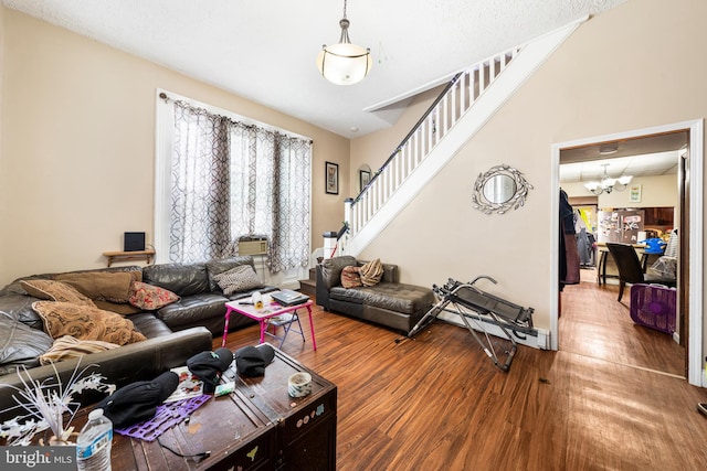 living room with hardwood / wood-style flooring, a healthy amount of sunlight, and an inviting chandelier