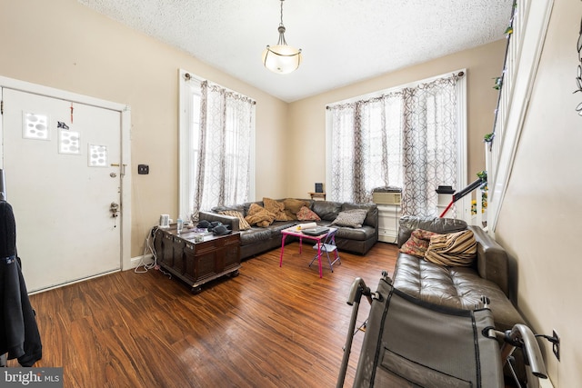 living room with hardwood / wood-style floors and a textured ceiling