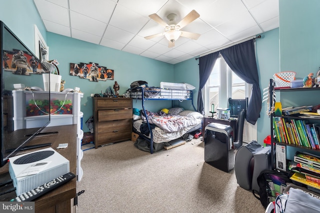 bedroom featuring carpet floors, a paneled ceiling, and ceiling fan