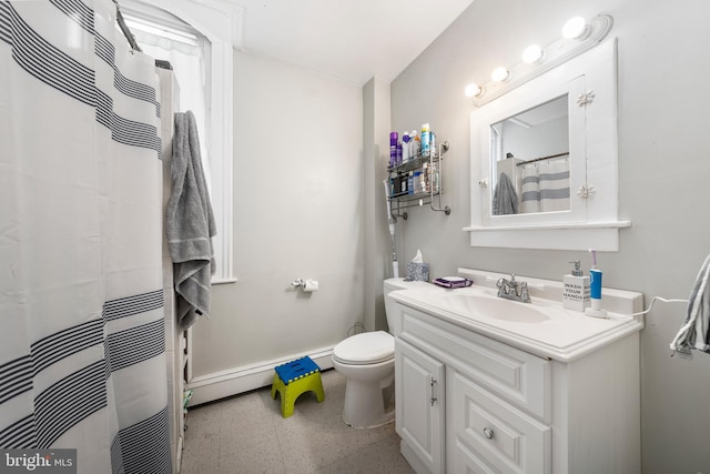 bathroom with vanity, baseboard heating, and toilet