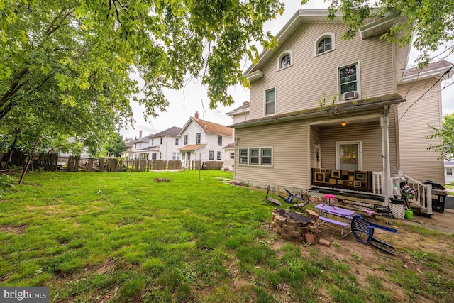 rear view of property featuring a lawn