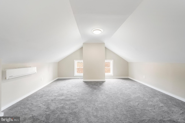 bonus room featuring lofted ceiling, a wall mounted air conditioner, and carpet