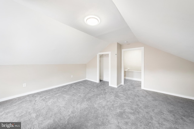 bonus room with lofted ceiling and carpet floors