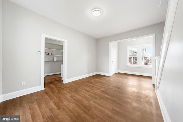 unfurnished room with wood-type flooring