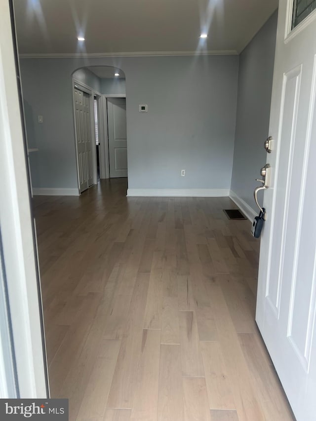 unfurnished room with ornamental molding and light hardwood / wood-style flooring