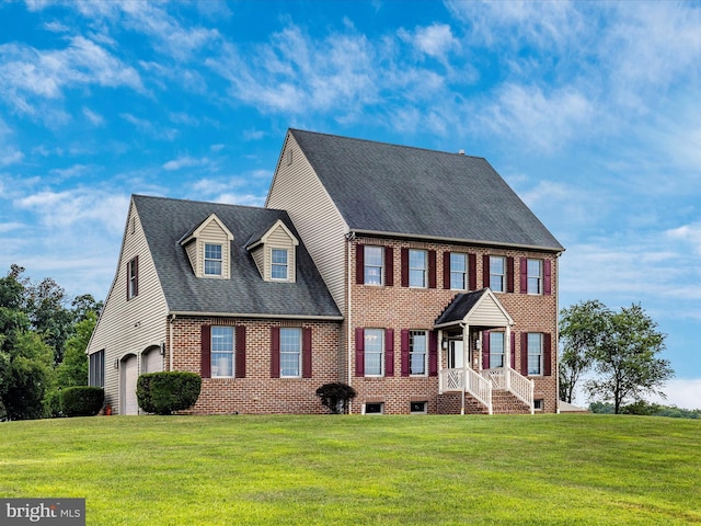 colonial home featuring a garage and a front yard