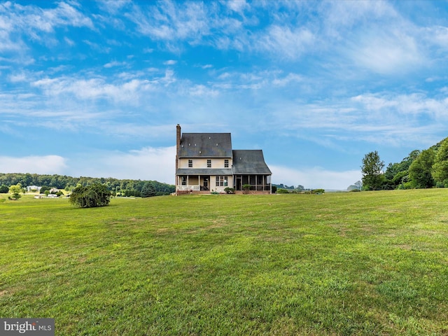 view of front of property featuring a rural view and a front lawn