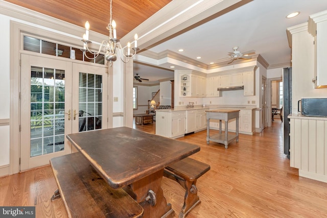 dining area featuring crown molding, ceiling fan with notable chandelier, french doors, and light wood-type flooring