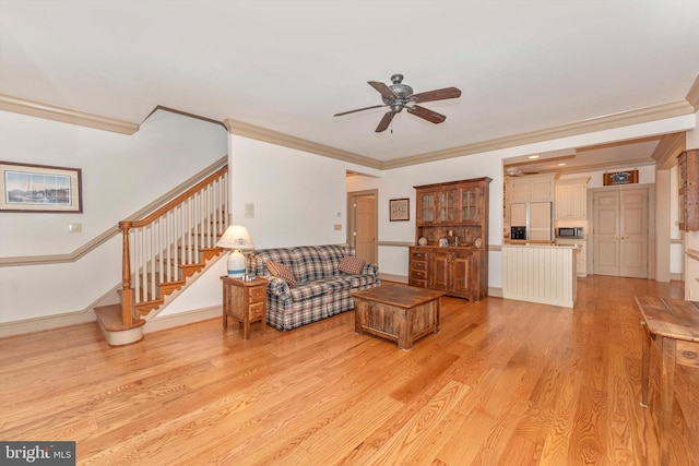 living room with crown molding, light hardwood / wood-style flooring, and ceiling fan