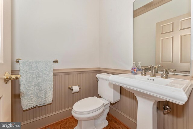 bathroom featuring hardwood / wood-style floors and toilet