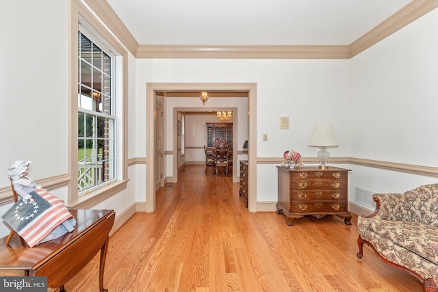 hall featuring crown molding and light wood-type flooring