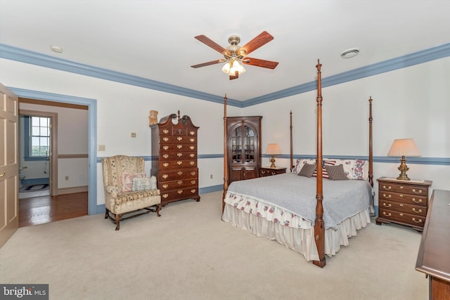 carpeted bedroom featuring crown molding and ceiling fan