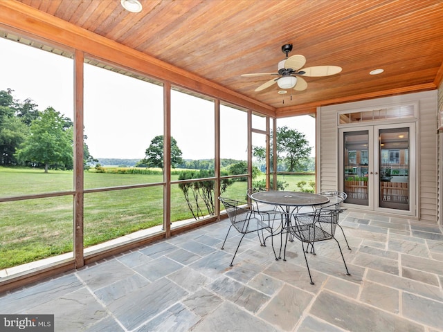 unfurnished sunroom with ceiling fan, wood ceiling, and french doors