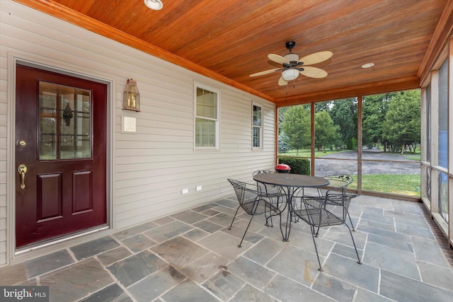 sunroom featuring wooden ceiling and ceiling fan