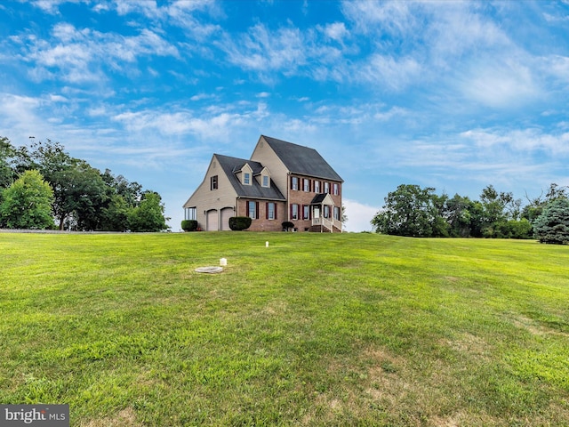 view of front of house with a garage and a front lawn