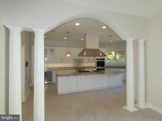 kitchen with white cabinetry, a kitchen island, island exhaust hood, and decorative light fixtures