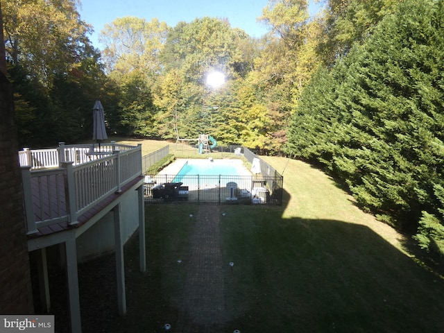 view of pool with a yard