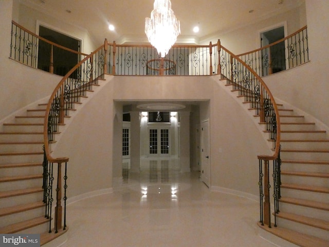 entrance foyer with a towering ceiling and an inviting chandelier