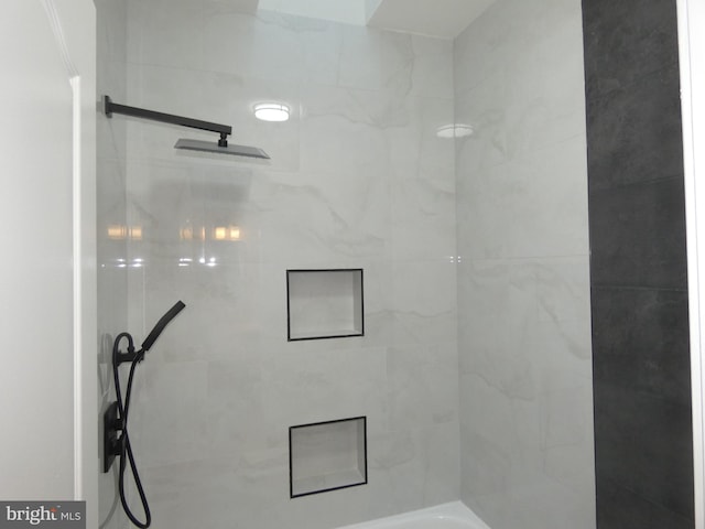 bathroom with a tile shower