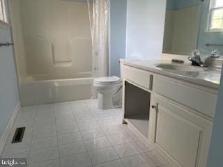 full bathroom featuring tile patterned flooring, shower / bathtub combination with curtain, toilet, and vanity