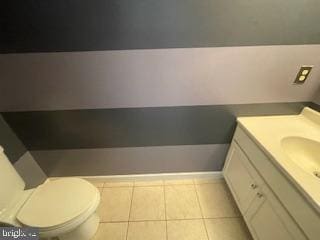 bathroom featuring tile patterned flooring, toilet, and vanity