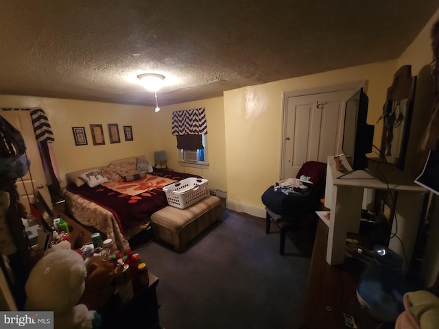 bedroom featuring carpet floors and a textured ceiling