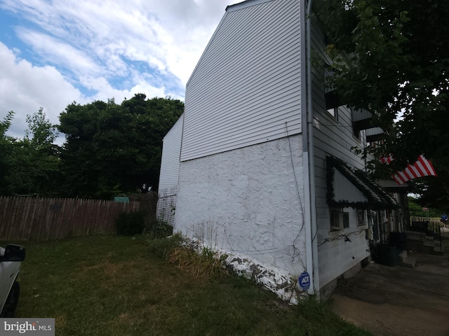 view of side of home with a lawn