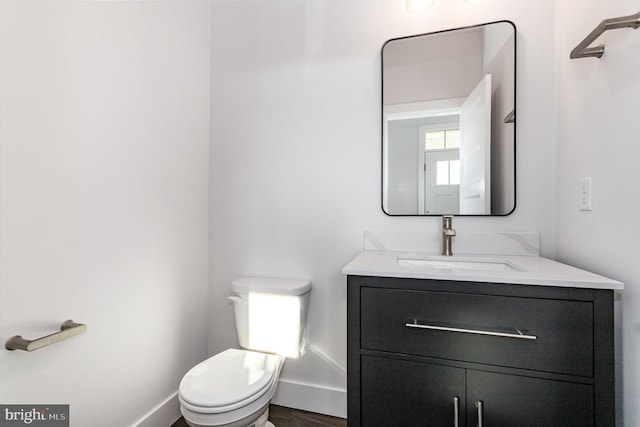 bathroom featuring vanity, toilet, and hardwood / wood-style floors