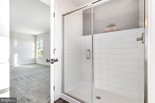 bathroom with a shower with door