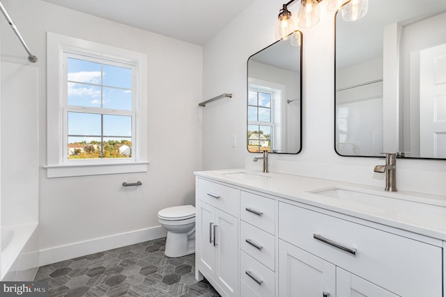 full bathroom featuring vanity, toilet, bathtub / shower combination, and plenty of natural light